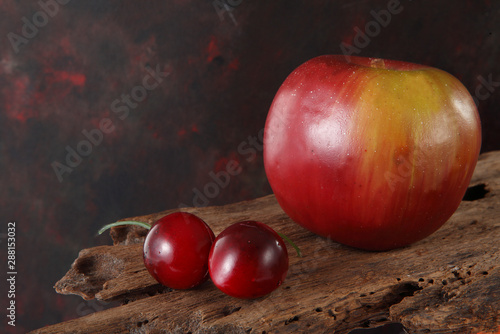 artificial apple and cherry with background