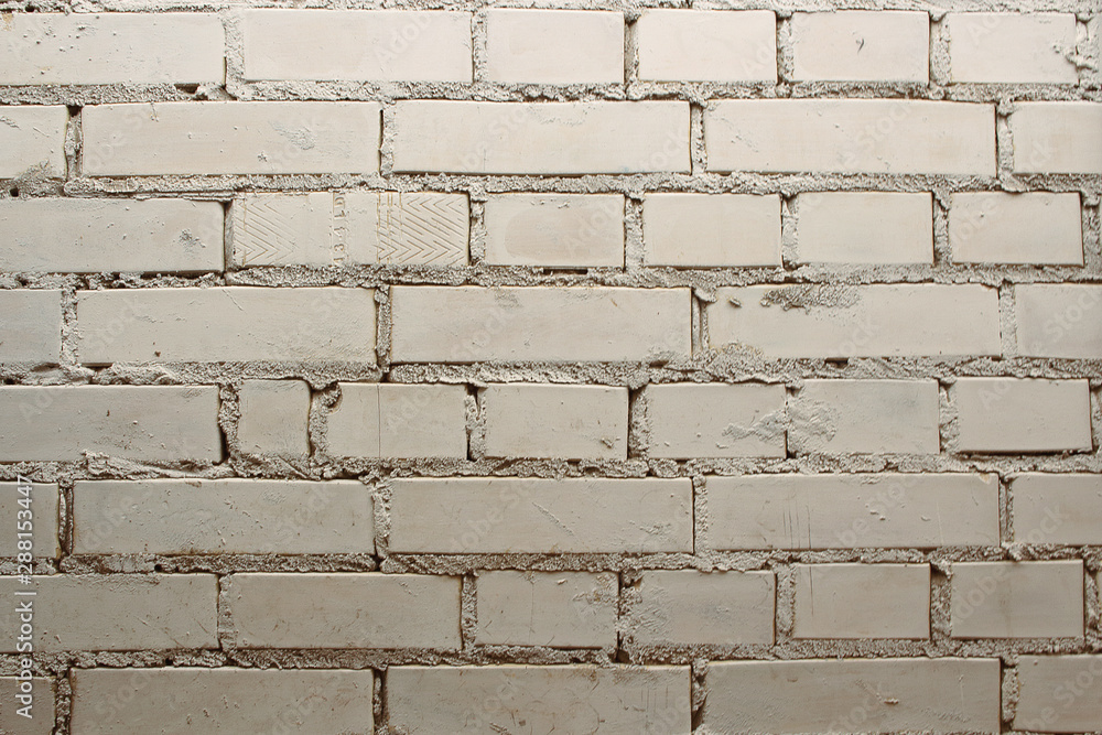Obraz premium Dirty old white exterior brick wall background