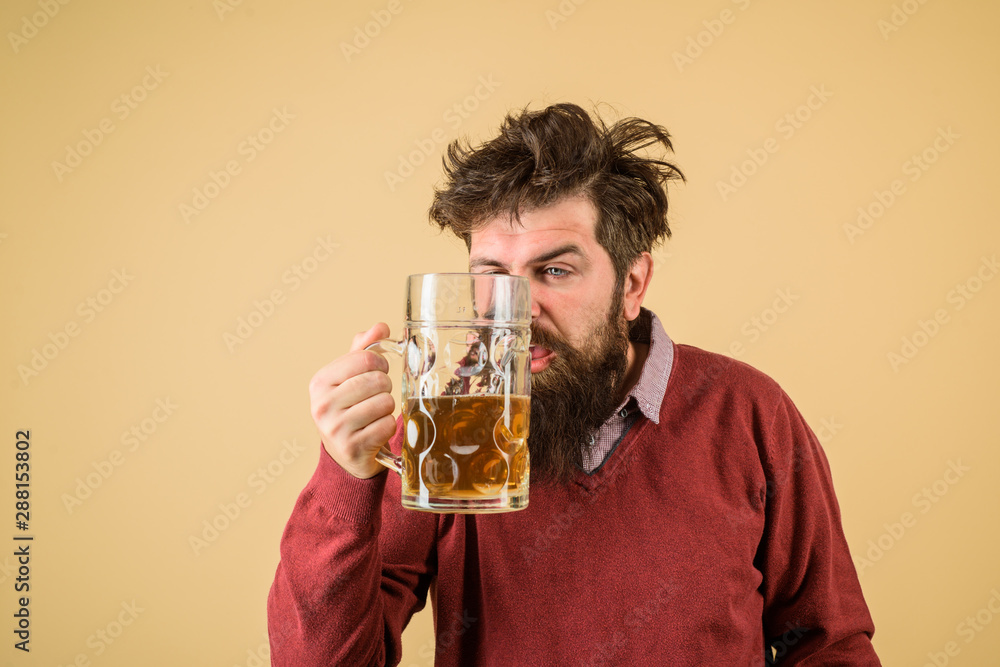 Male brewer holds glass with beer. Oktober fest. Tasting fresh brewed beer. Brewer holds glass with craft beer. Brewery concept. Oktoberfest festival. Alcohol. Man with beer of mug. Barman. Brewer. Male brewer holds glass with beer. Oktober fest. Tasting fresh brewed beer. Brewer holds glass with craft beer. Brewery concept. Oktoberfest festival. Alcohol. Man with beer of mug. Barman. Brewer.