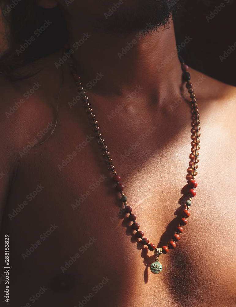 Male chest with mala mineral stone lotus pendant necklace