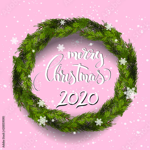  Merry Christmas 2020 lettering text on pink background. fir wreath frame.