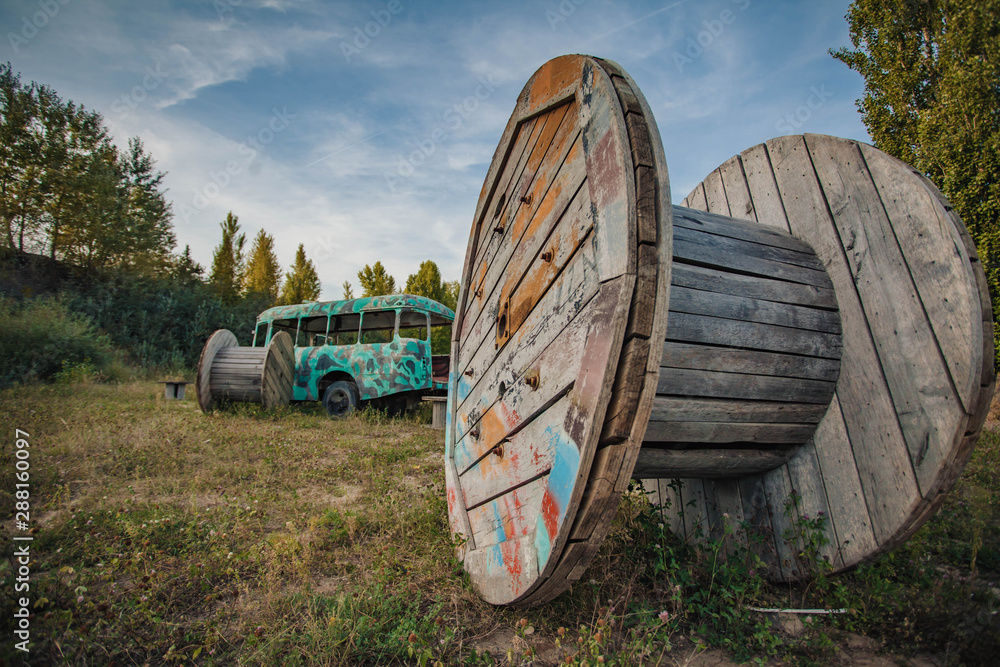 old abandoned bus green in the field