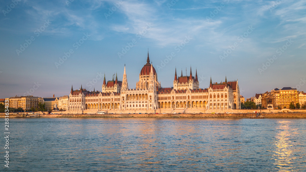 Fototapeta premium The Hungarian Parliament Building, a notable landmark of Hungary in Budapest. View of the main facade above the Danube river at a sunset.