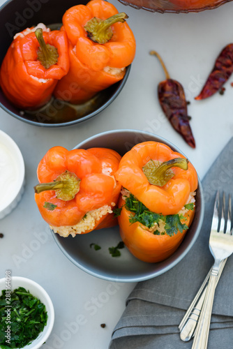 Colorful stuffed peppers on gray wooden background. Selective focus. Healthy food concept