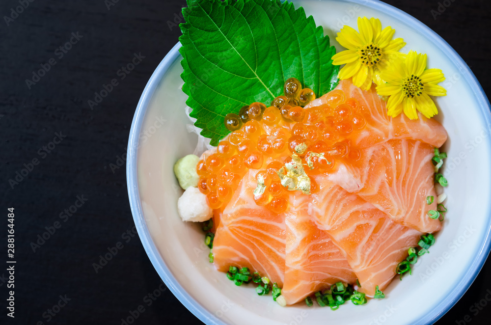 Salmon sashimi with salmon's egg (Ikura) in bowl.
