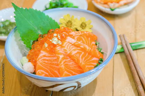 Salmon sashimi with salmon's egg (Ikura) in bowl.