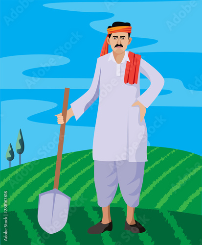 indian farmer standing in farm with shovel