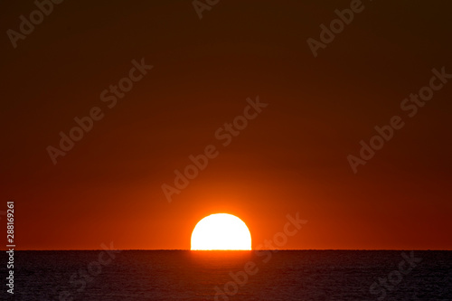 Fototapeta Naklejka Na Ścianę i Meble -  Rising Sun Over Ocean