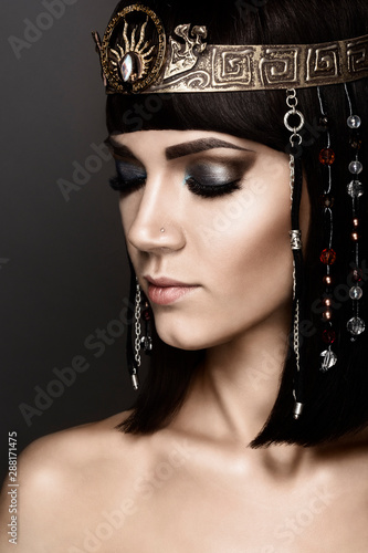Close-up portrait of beautiful woman with bright make-up. Cleopatra