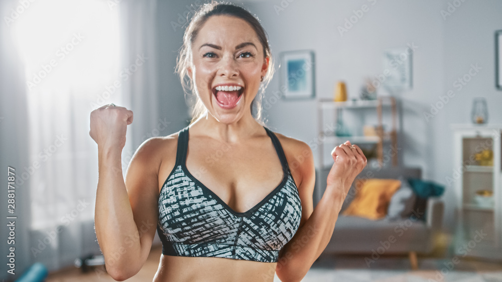 Strong and Fit Beautiful Busty Girl in an Athletic Top is Posing After a  Workout at Home in Her Spacious and Sunny Living Room with Minimalistic  Interior. Stock Photo | Adobe Stock