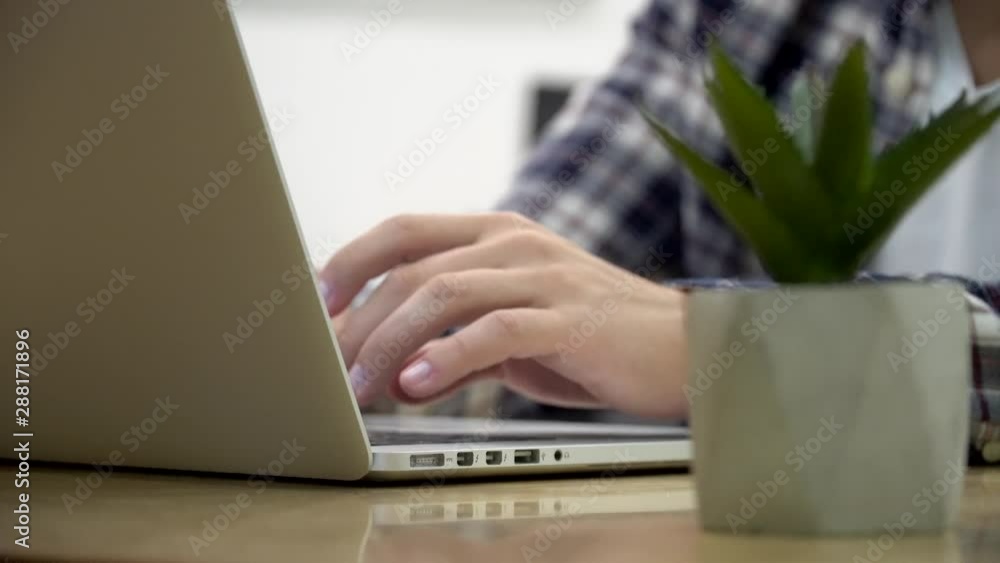 Working on laptop computer. Freelancer's hands typing on laptop keyboard text. Business concept.Hands typing on computer keyboard and touching touchpad with fingers. Business man working on laptop. Working on laptop computer. Freelancer's hands typing on laptop keyboard text. Business concept.Hands typing on computer keyboard and touching touchpad with fingers. Business man working on laptop.