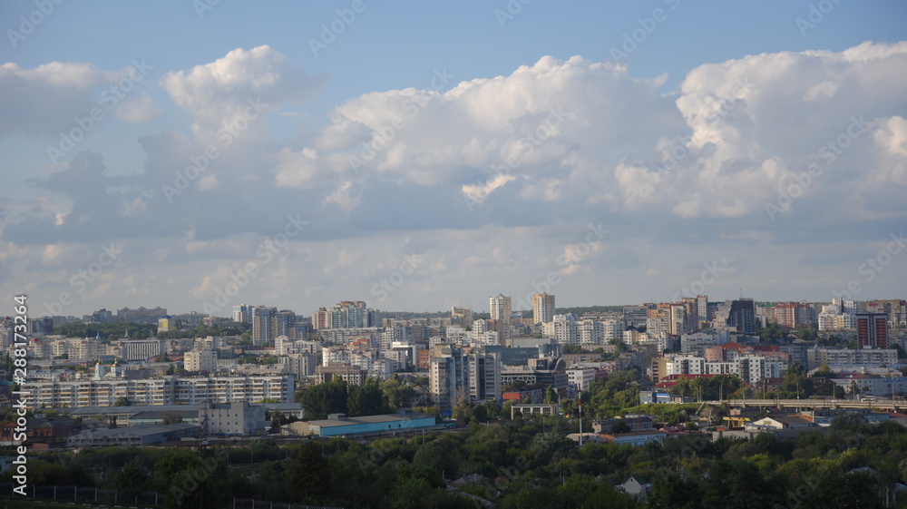  panoramic top view of tall houses against the sky with white clouds