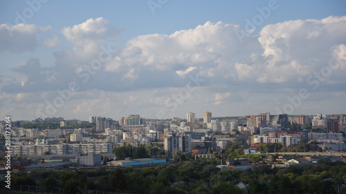  panoramic top view of tall houses against the sky with white clouds