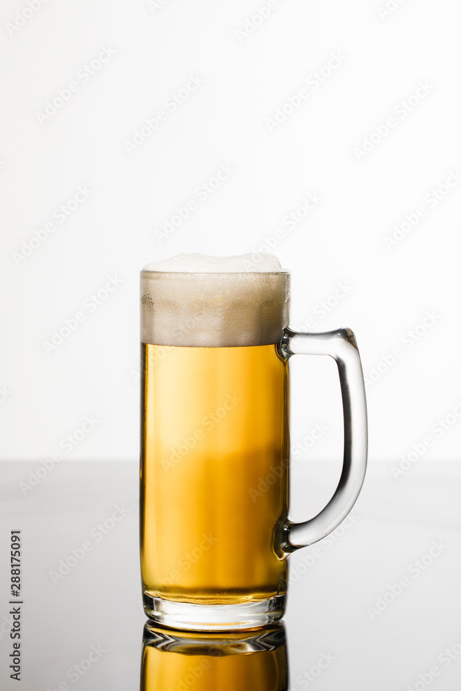 glass of beer with foam isolated on white glass of beer with foam isolated on white