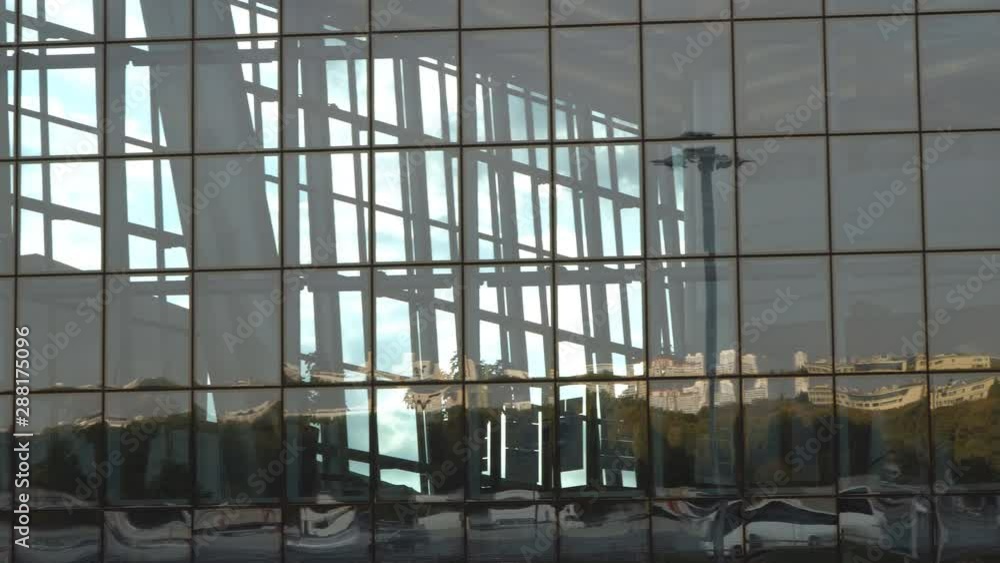 Reflection of traffic and parking lot in the glass of a modern building Reflection of traffic and parking lot in the glass of a modern building