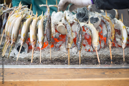 Charcoal grilled Ayu fish with salt. Traditional Japanese street food at Kegon waterfall in Nikko, Japan. photo