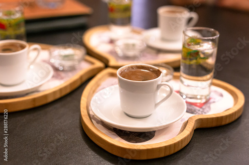 Traditional turkish coffee table setting. Heart shaped wooden tray. © bulgn