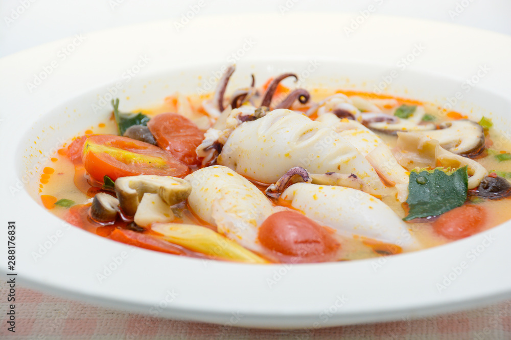 Squids and lemon grass spicy soup with mushrooms, tomatoes and herbs Squids and lemon grass spicy soup with mushrooms, tomatoes and herbs