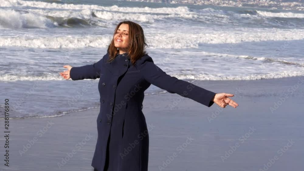 Beautiful woman enjoy autumn in front of the ocean slow motion Beautiful woman enjoy autumn in front of the ocean slow motion