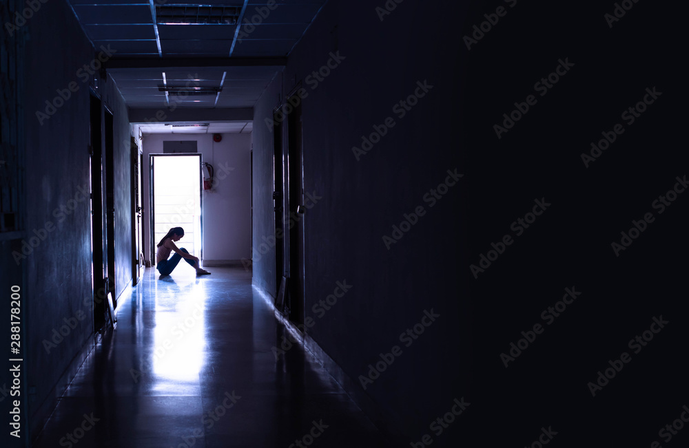 Silhouette of a sad young girl sitting in the dark, thinking about problem with relationships or work, feeling despair and anxiety, loneliness, having psychological trouble. - obrazy, fototapety, plakaty 