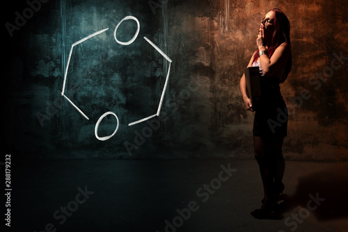 Sexy girl or secretary or female student presenting handdrawn chemical formula of Dioxane photo