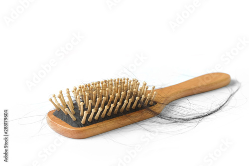 Isolated wooden brush with hair on white background