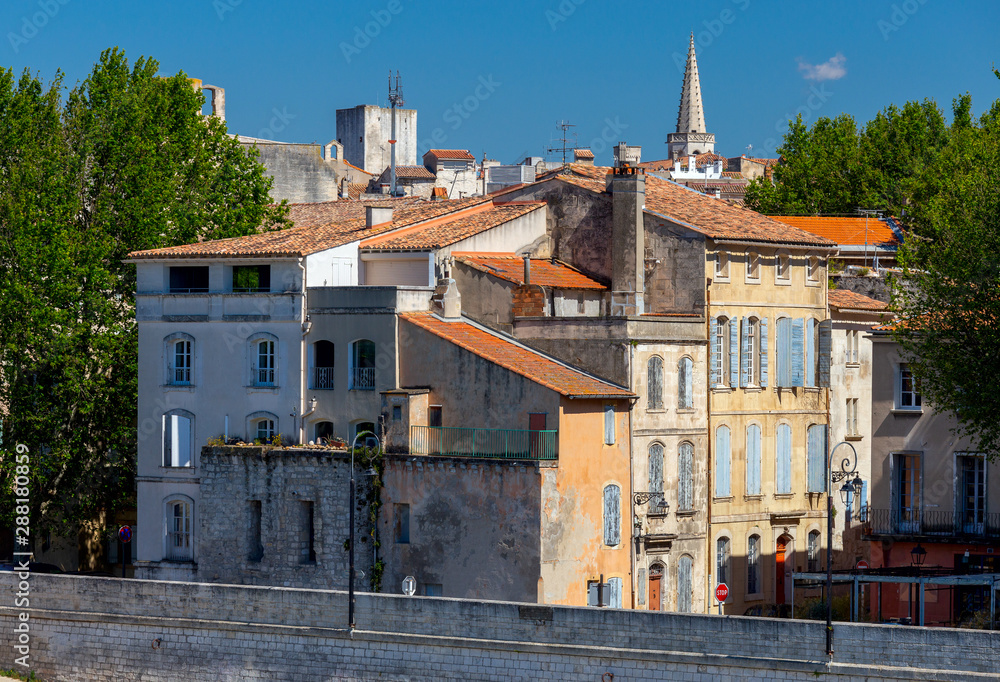 Arles. City embankment and facades of old houses.