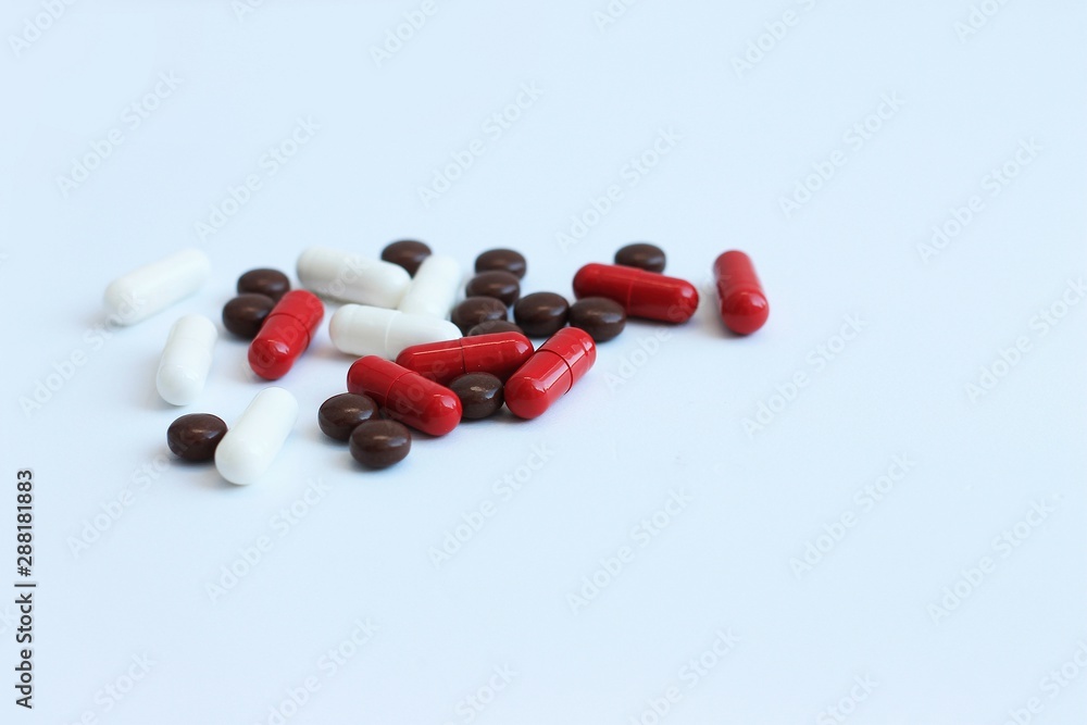 Multi-colored capsules isolated on white background, copy space. Pain meds, for health. Multi-colored capsules isolated on white background, copy space. Pain meds, for health.
