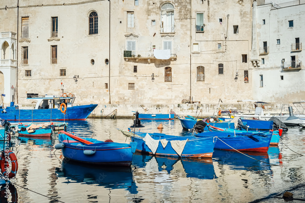Monopoli, Puglia Italy - Thursday 22 August 2019: Boats moored at the old port of Monopoli, Puglia Italy
