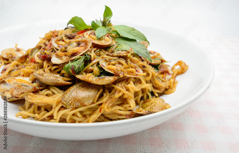 Stir fried noodles with clams and herbs, hot and spicy dish Stir fried noodles with clams and herbs, hot and spicy dish