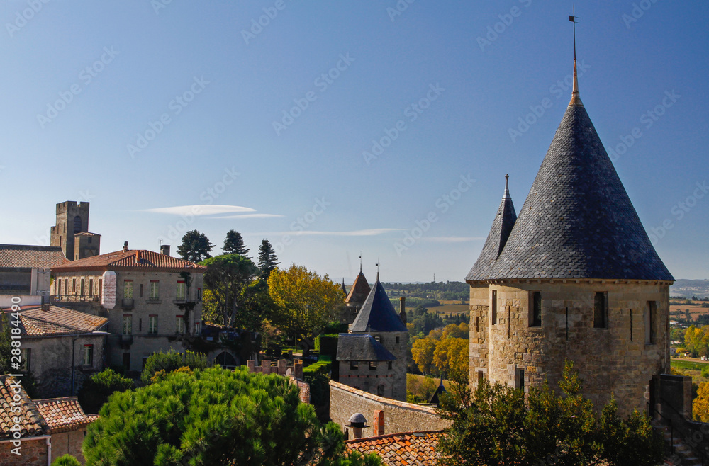 La Cité Carcassonne, Languedoc-Roussillion, France, Europe. Sunny day with blue sky showing watchtowers and tiled roofs. UNESCO World Heritage Site