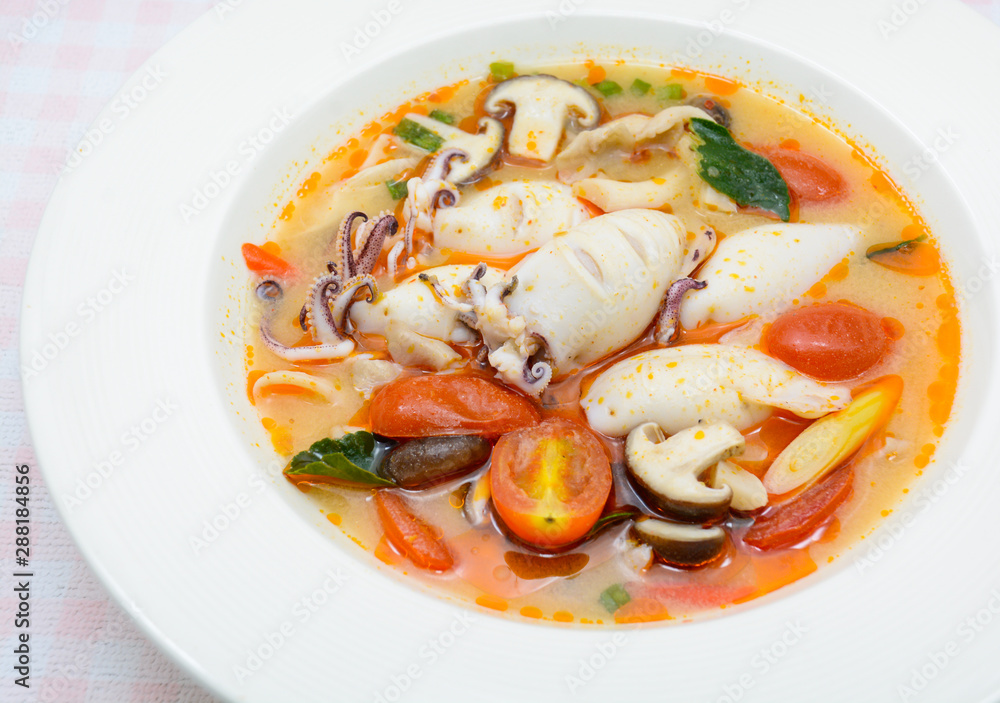 Squids and lemon grass spicy soup with mushrooms, tomatoes and herbs Squids and lemon grass spicy soup with mushrooms, tomatoes and herbs