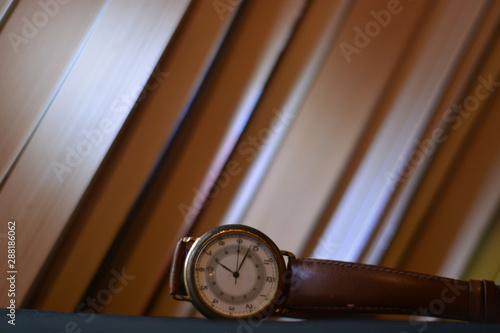 a clock in front of the books