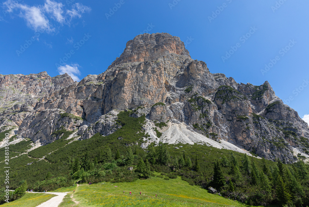 Sassongher mountain view from the foot with hiking paths and hikers. Italian Dolomites. Italian Alps, Colfosco - Alta Badia.