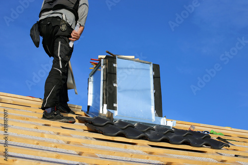 Roofer working on exterior chimney cladding Fototapete