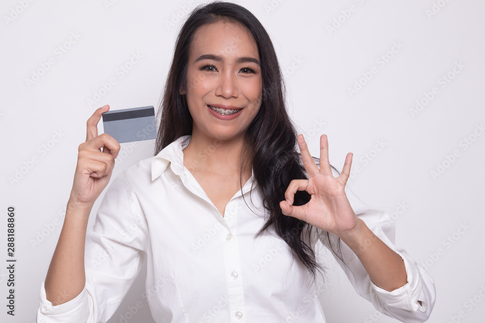 Young Asian woman show OK with a blank card. Young Asian woman show OK with a blank card.