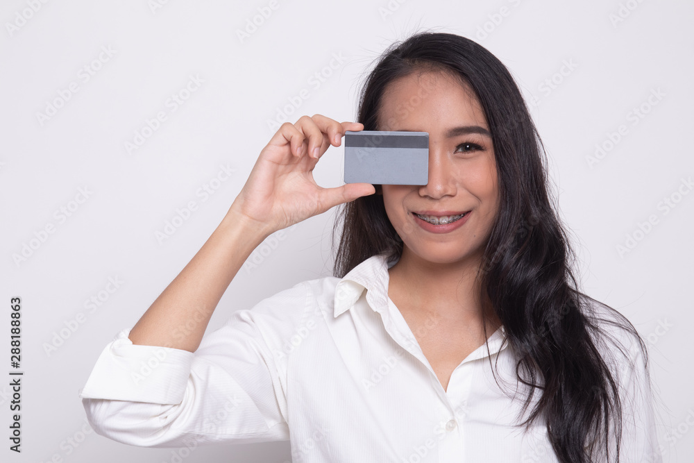 Young Asian woman with blank card over her eye. Young Asian woman with blank card over her eye.