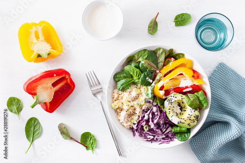 veggie couscous lunch bowl with avocado, bell peppers, spinach and red cabbage photo