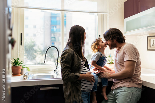 Adorable happy family playing with toys at home