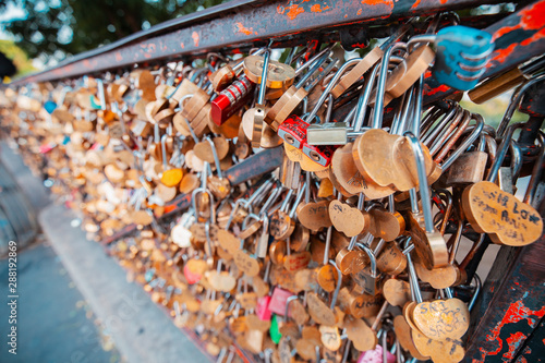 Lovers hang padlocks on bridges and fences in Paris, causing heated debate among the urban public