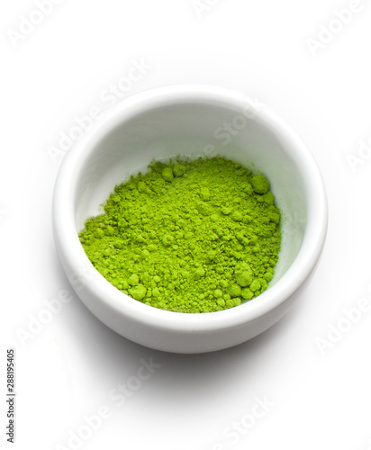 white ceramic cup containing powdered matcha tea, isolated on white and with shading