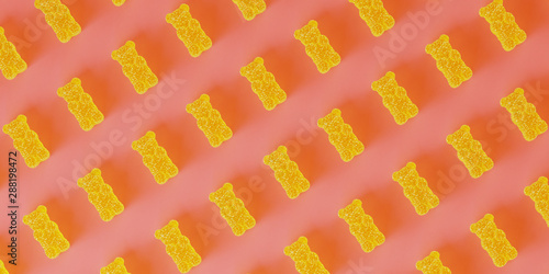 Abstract pattern background of sweet candies for happiness concept. Yellow jelly bears with sugar crystals on pink background. 3d rendering illustration. photo