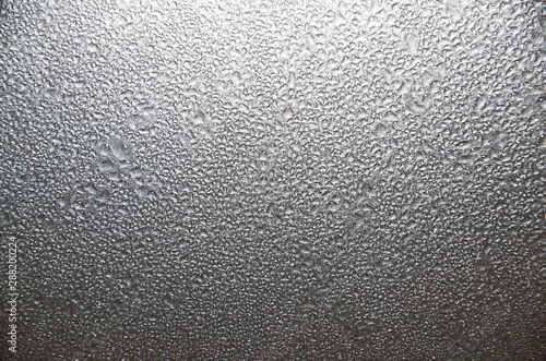 Background, water droplets on a gray glossy surface.