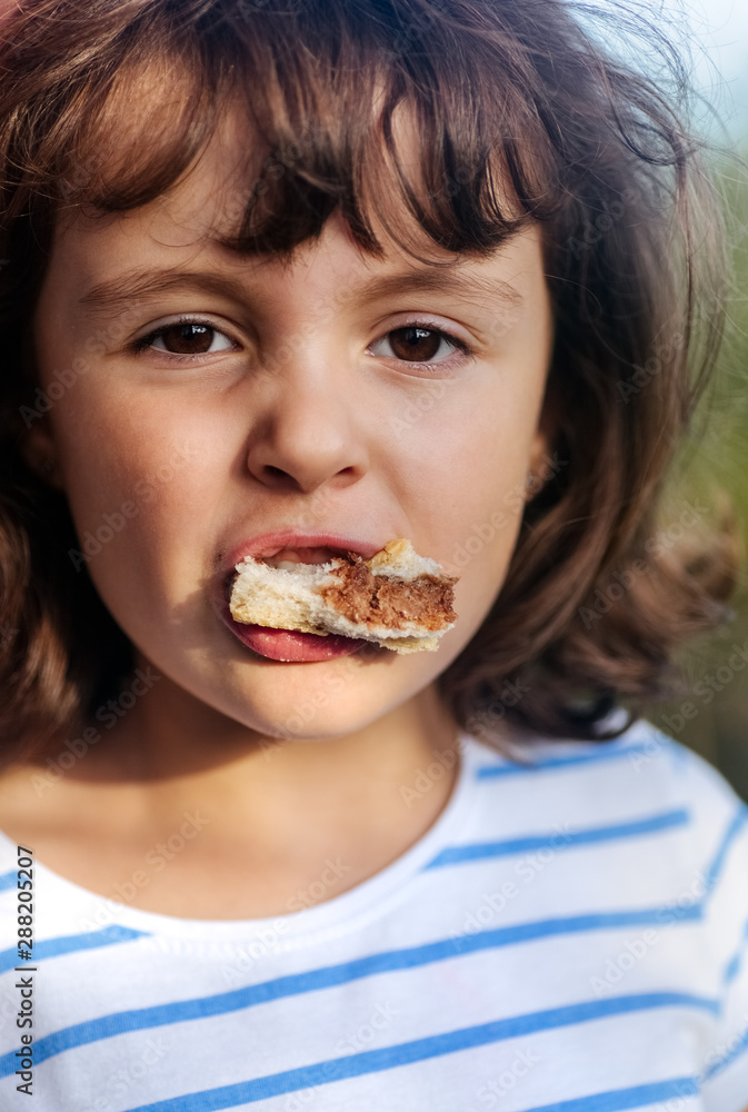 Portrait of a little girl eating a sandwich Portrait of a little girl eating a sandwich