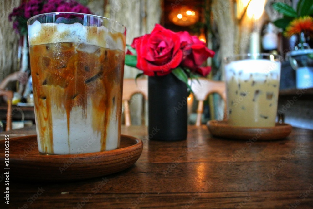 Iced coffee on a wooden table in a vintage style cafe