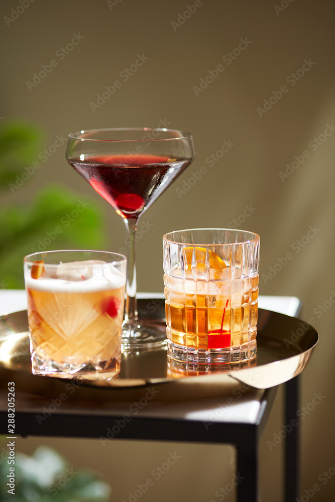 Three cocktails served on tray. Three cocktails served on tray.