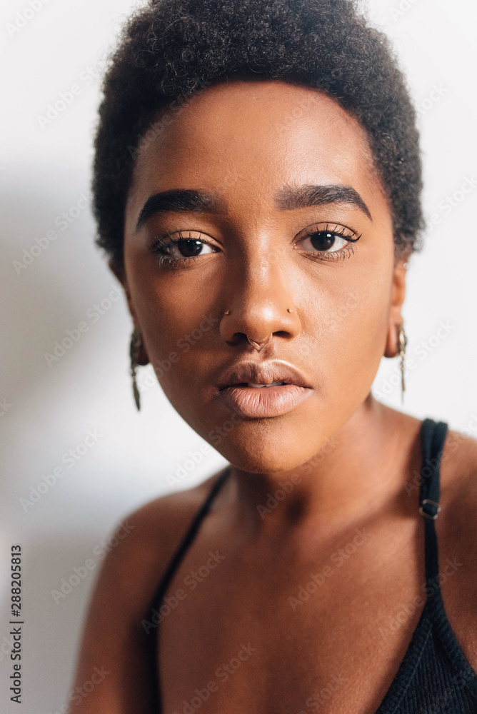 Portraits of a beautiful young black woman against a white wall Portraits of a beautiful young black woman against a white wall