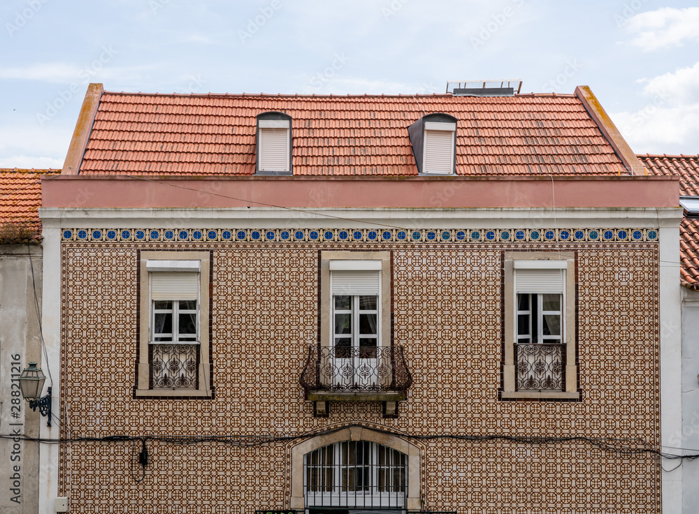 Decorative ceramic tiles on a large house with balconies in Alfama district of Lisbon, Portugal