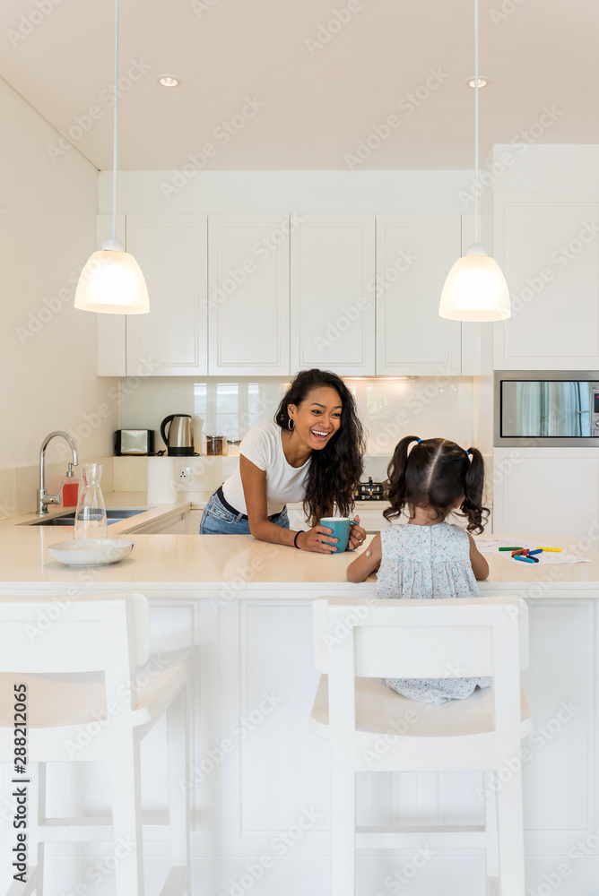 Mother and daughter having breakfast in the kitchen Mother and daughter having breakfast in the kitchen