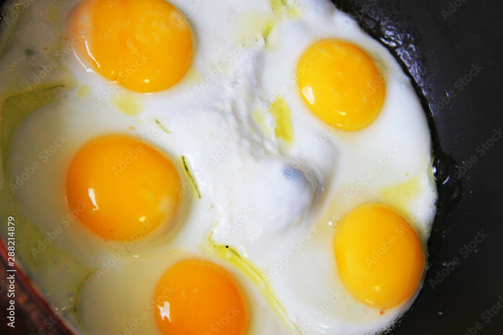 Whole roasted eggs on the black pan Whole roasted eggs on the black pan